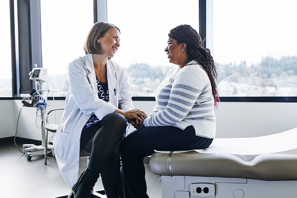 Physician comforting female patient